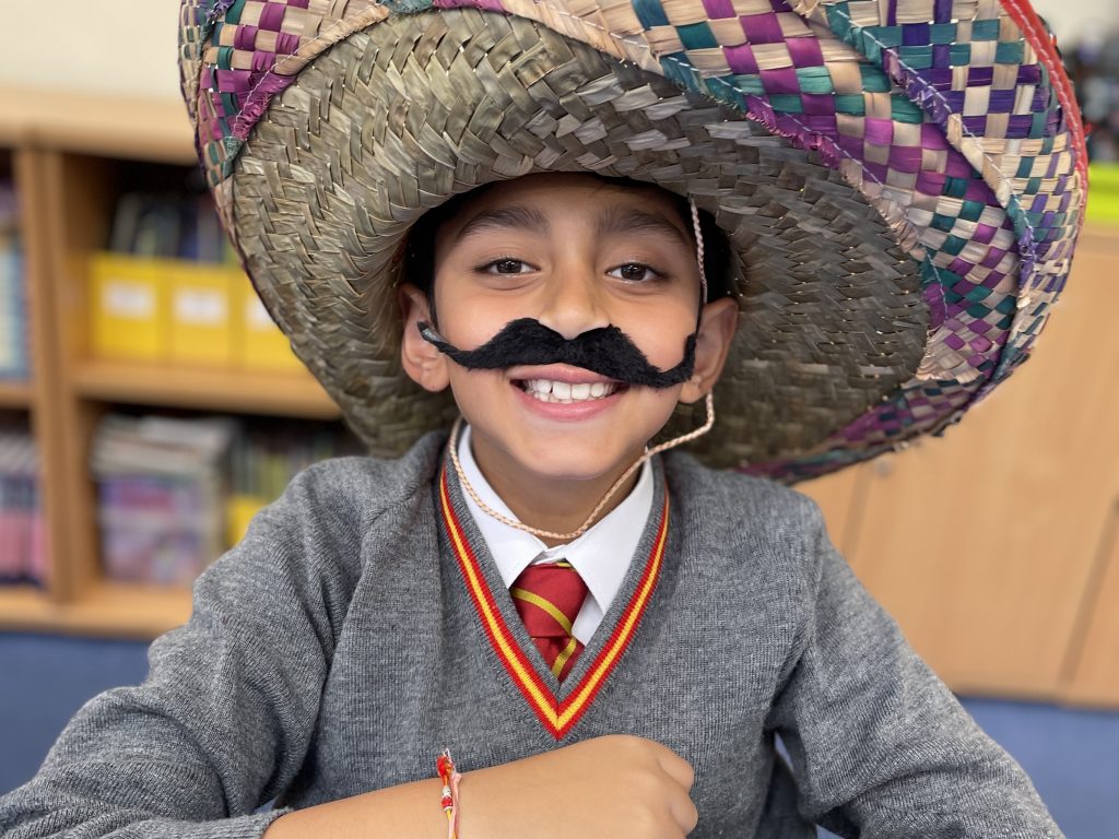 student wearing a big hat and moustache